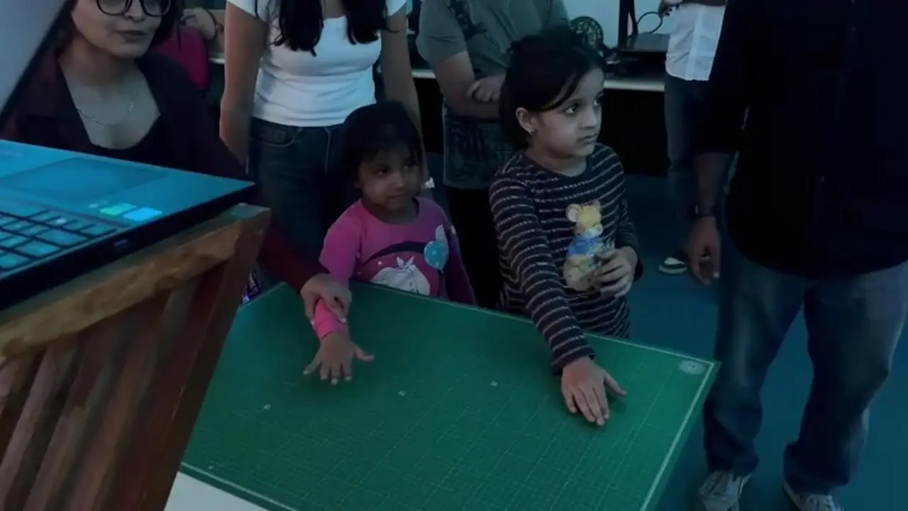 Kids playing PIN and POP in front of the projected wall